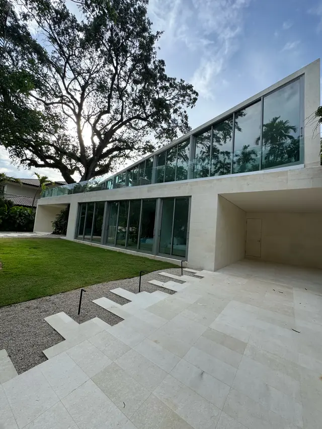 Finished modern home with a band of impact windows on the second floor