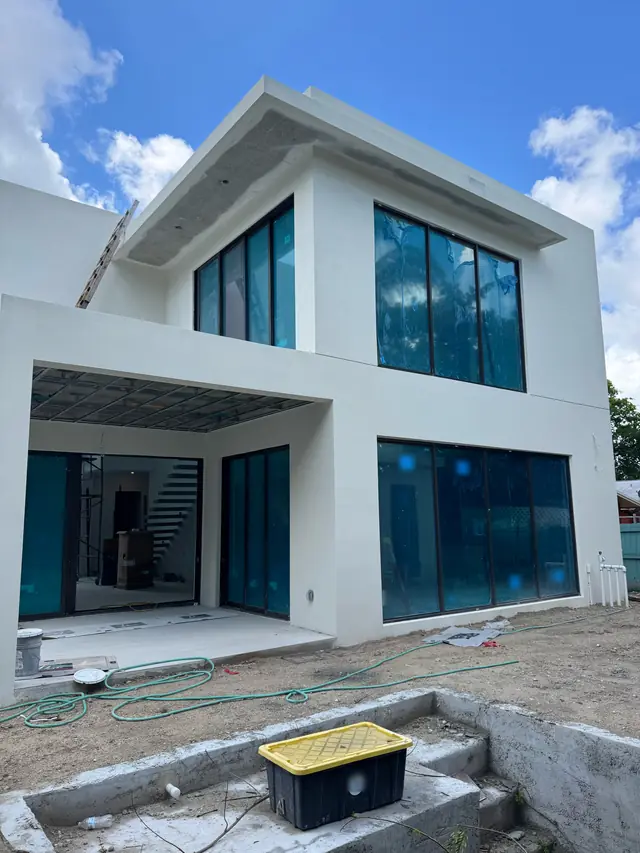 Two-story white home with impact windows and doors installed
