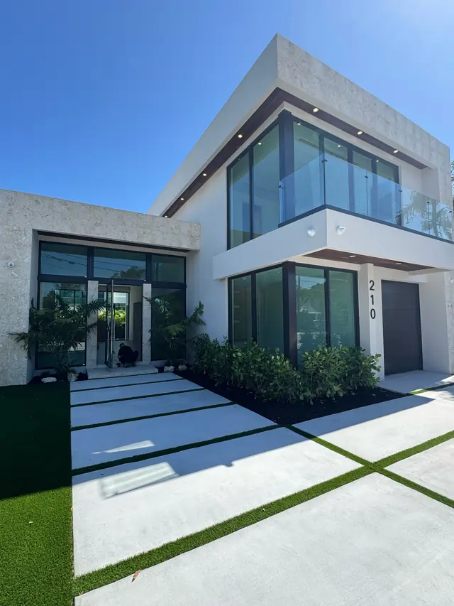 Finished modern two-story home with large impact glass windows and doors