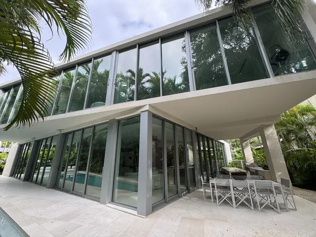 Finished home with floor-to-ceiling impact windows and doors by the pool