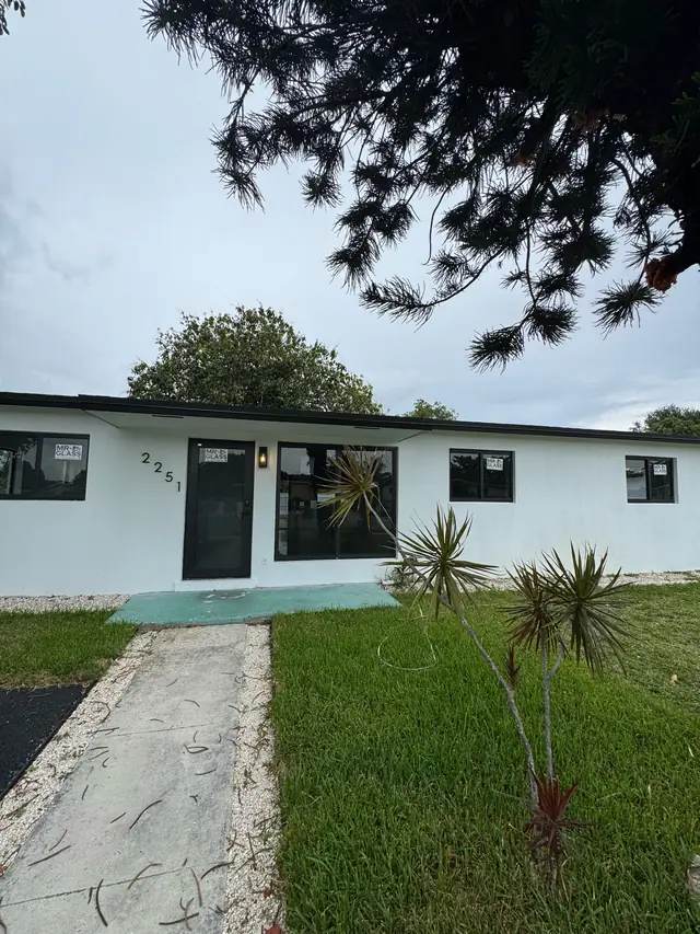 Single-story home with newly installed black-frame impact windows and door