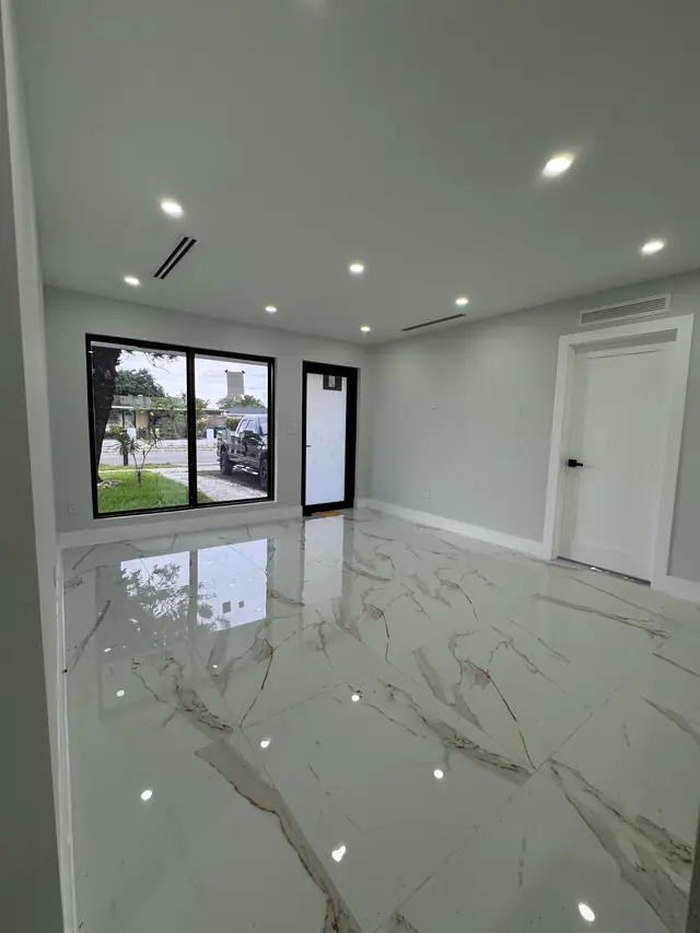 Finished interior with a black-frame impact window and door